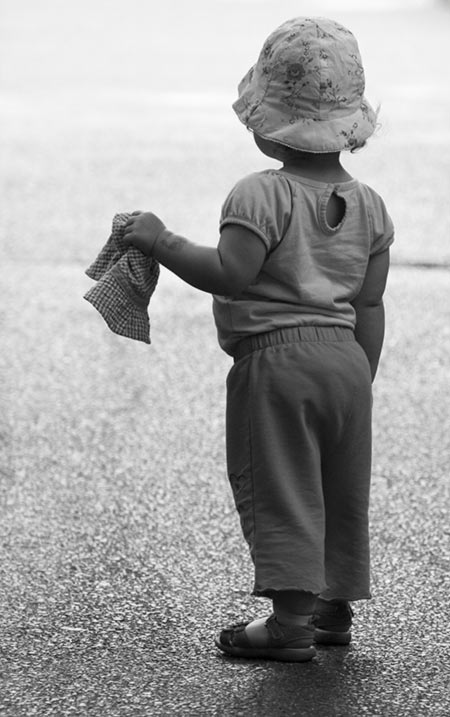 Ella holding a hat in black and white