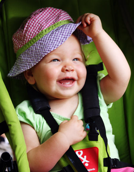 Ella tipping her hat in her stroller