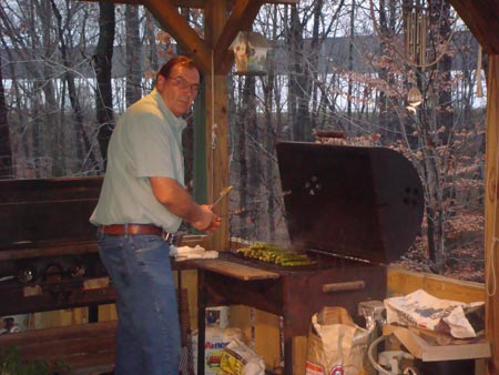 Mr. Naude cooking vegetables out on the grill.