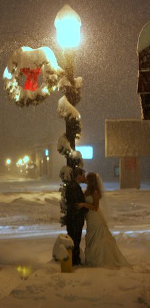 Linday and Luke kissing in the snow on their wedding day.